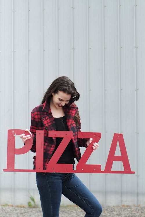 A Woman Holding A Red Pizza Signboard