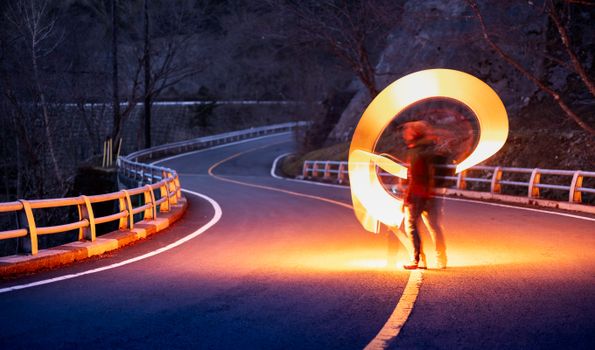 Enchanting light painting on a deserted mountain road in Nikko, Japan at night.