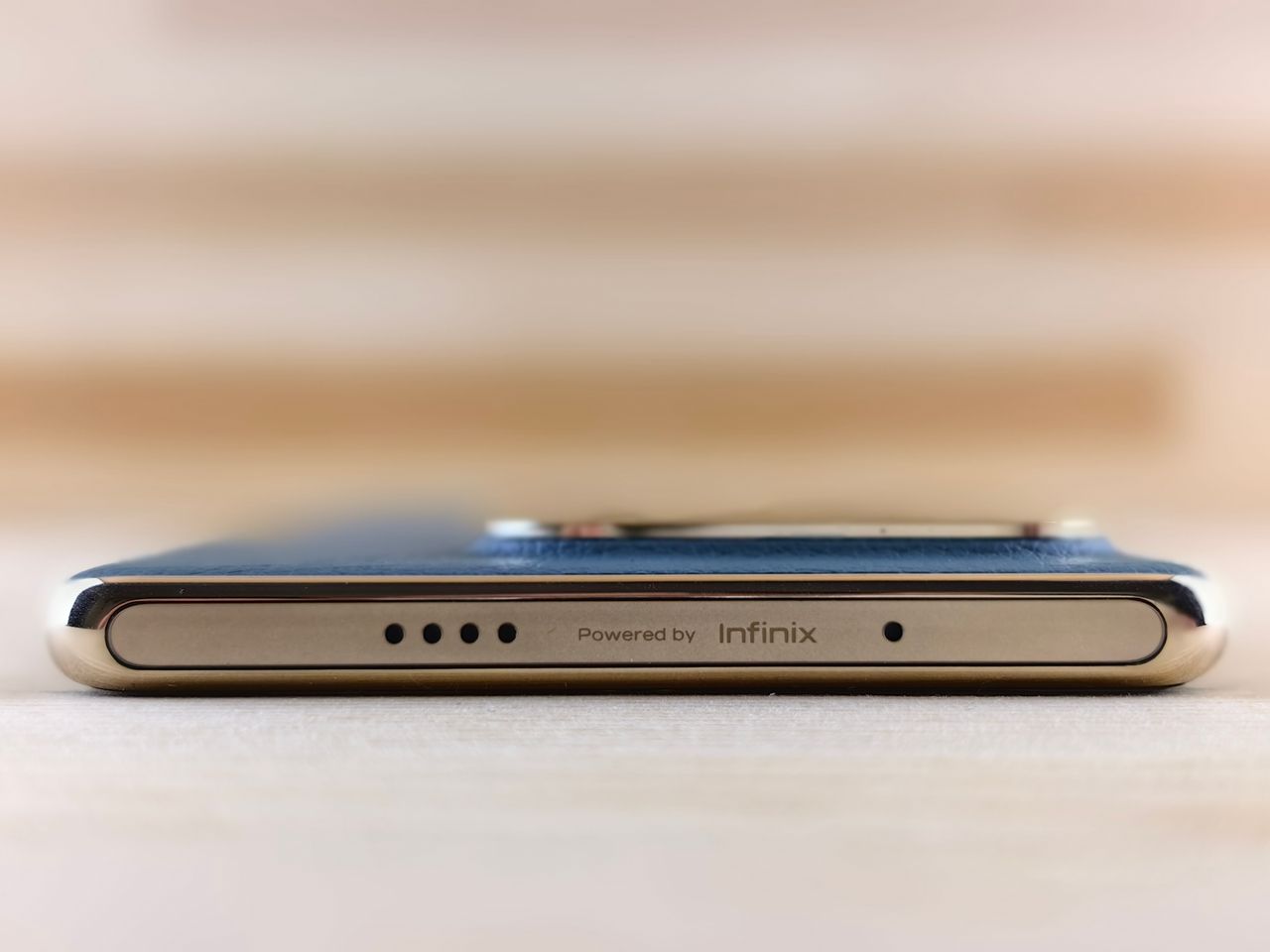 close up view of the sleek edge of a smartphone featuring infinix bran
