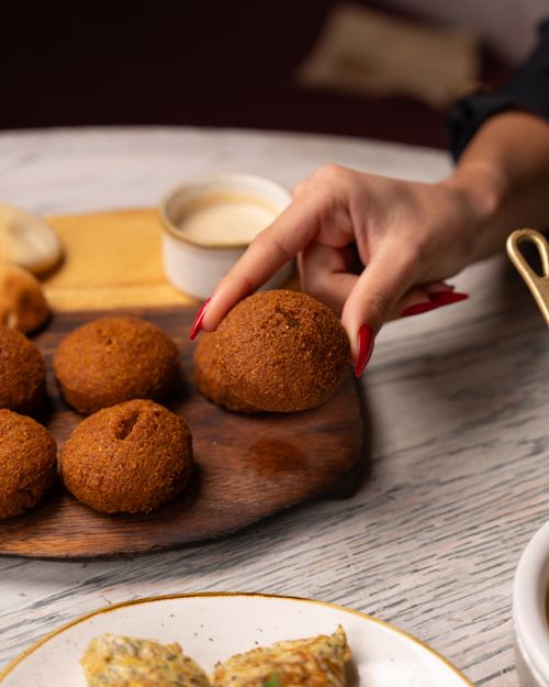 Free Delicious homemade falafel served with a side of dipping sauce, perfect for a savory snack. Stock Photo