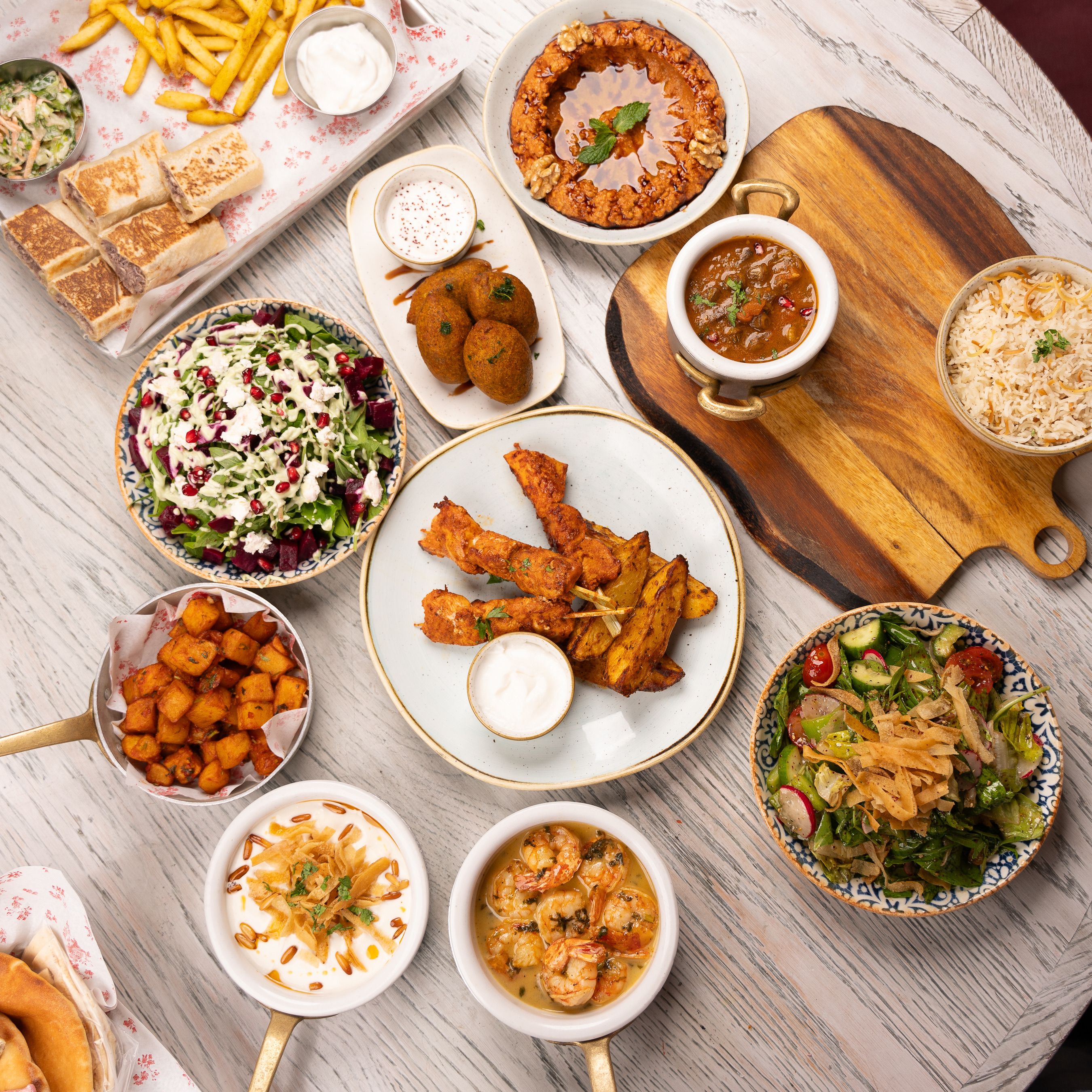 A vibrant spread of Middle Eastern cuisine featuring salads, appetizers, and main courses.