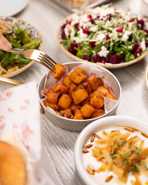 Free Vibrant Mediterranean tapas spread with a fresh salad and creamy dip, perfect for sharing. Stock Photo