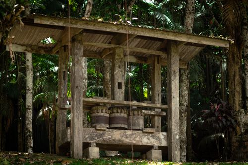 Free An ancient sugar press amid lush tropical forest, showcasing rustic architecture in nature. Stock Photo