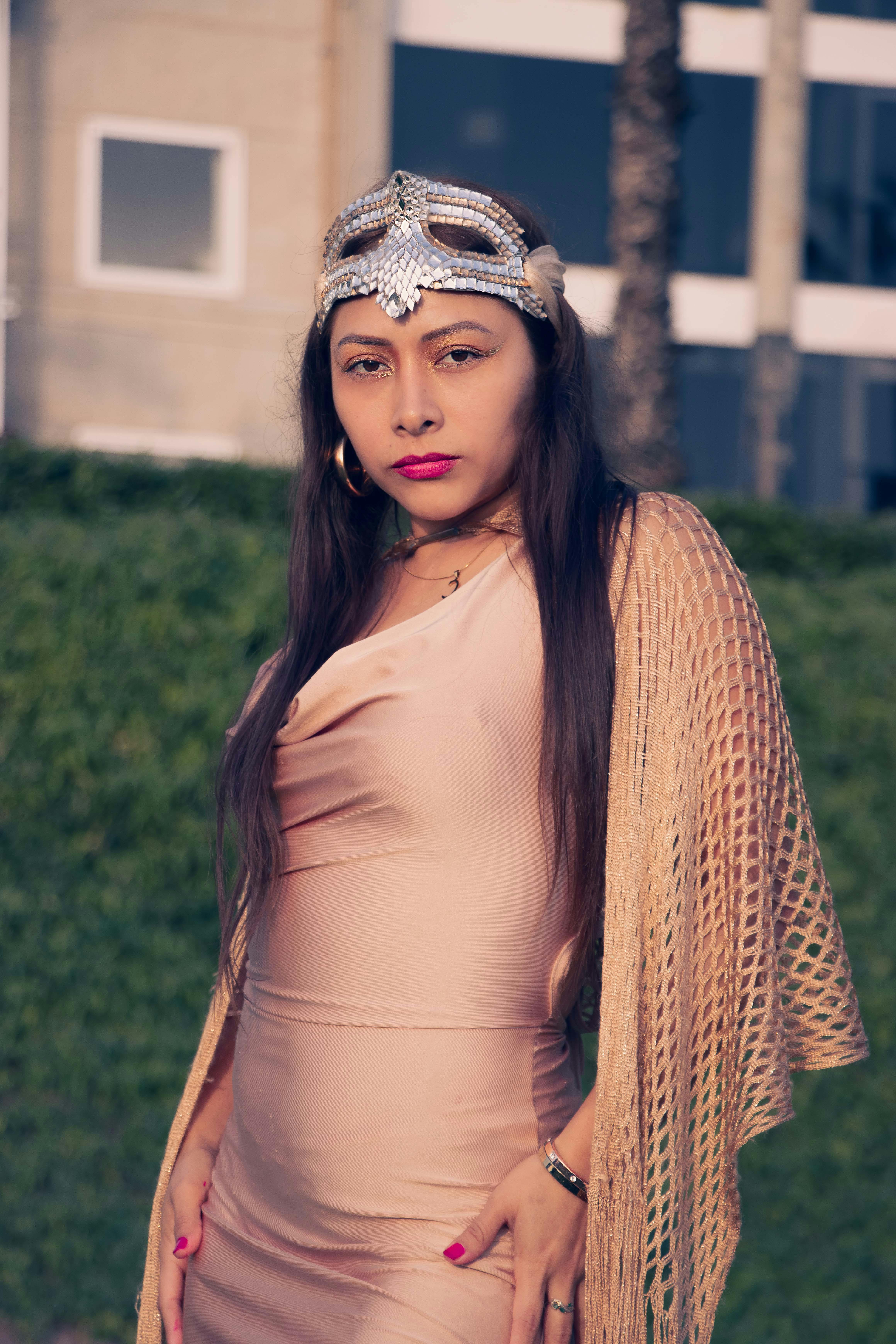 Elegant woman wearing a decorative mask, posing outdoors in Lima, Perú