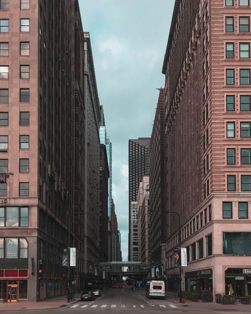 Free Dramatic urban street scene with towering buildings and a city road in downtown Chicago. Stock Photo