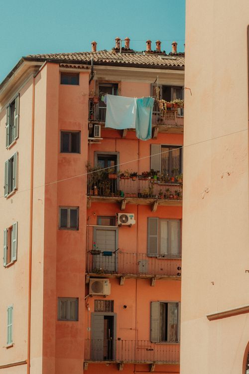 Free Charming rustic apartment building with balconies and laundry hanging outdoors. Stock Photo