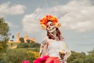 A woman in Day of the Dead makeup and costume at San Andrés Cholula, Mexico.