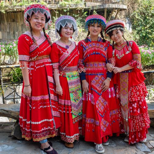 Free Women in vibrant traditional Hmong dresses in Lao Cai, Vietnam showcasing cultural apparel outdoors. Stock Photo