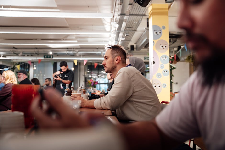 A vibrant networking event in Lynchburg with cybersecurity professionals engaging in lively conversation, showcasing the essence of collaboration and connection in the industry.. Mike González caught the moment