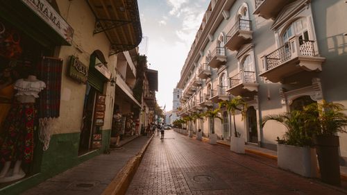 Free A picturesque old street in Panama City with historic buildings and lively street scene at sunset. Stock Photo