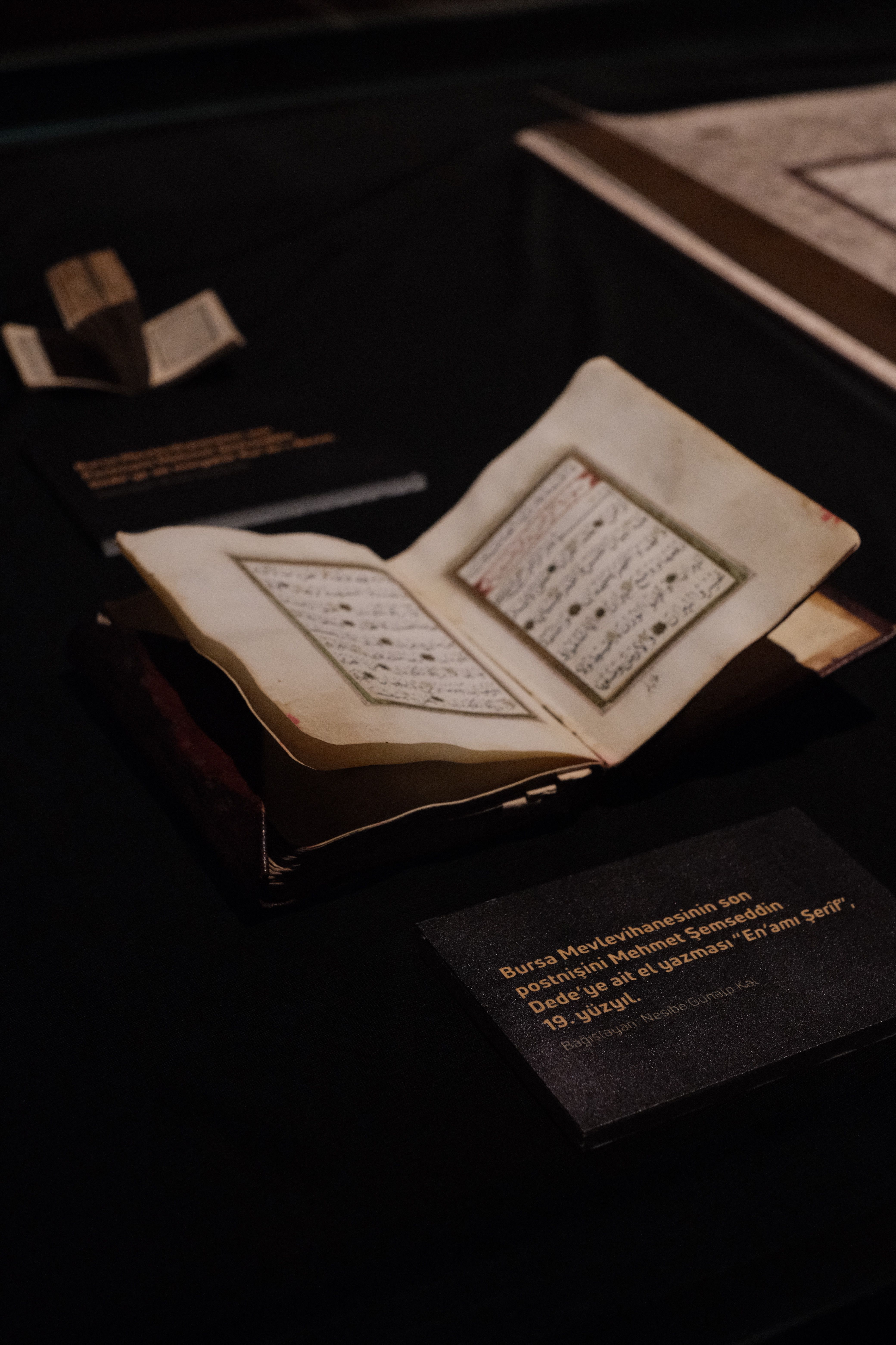 Antique Manuscript Display in Dimly Lit Museum · Free Stock Photo
