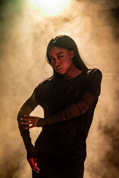 Free Moody portrait of a fashionable person enveloped in dramatic lighting and smoke. Stock Photo