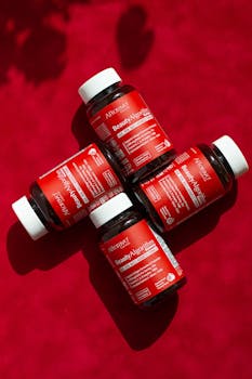 Top view of BeautyAlgorithm vitamin supplements on red background for hair and skin health.