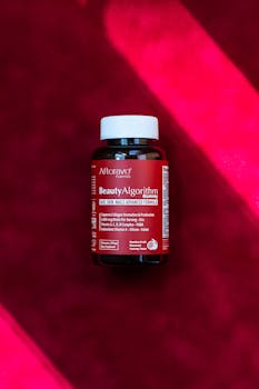 Afterave Beauty Algorithm hair skin nails gummies resting on vibrant red surface.