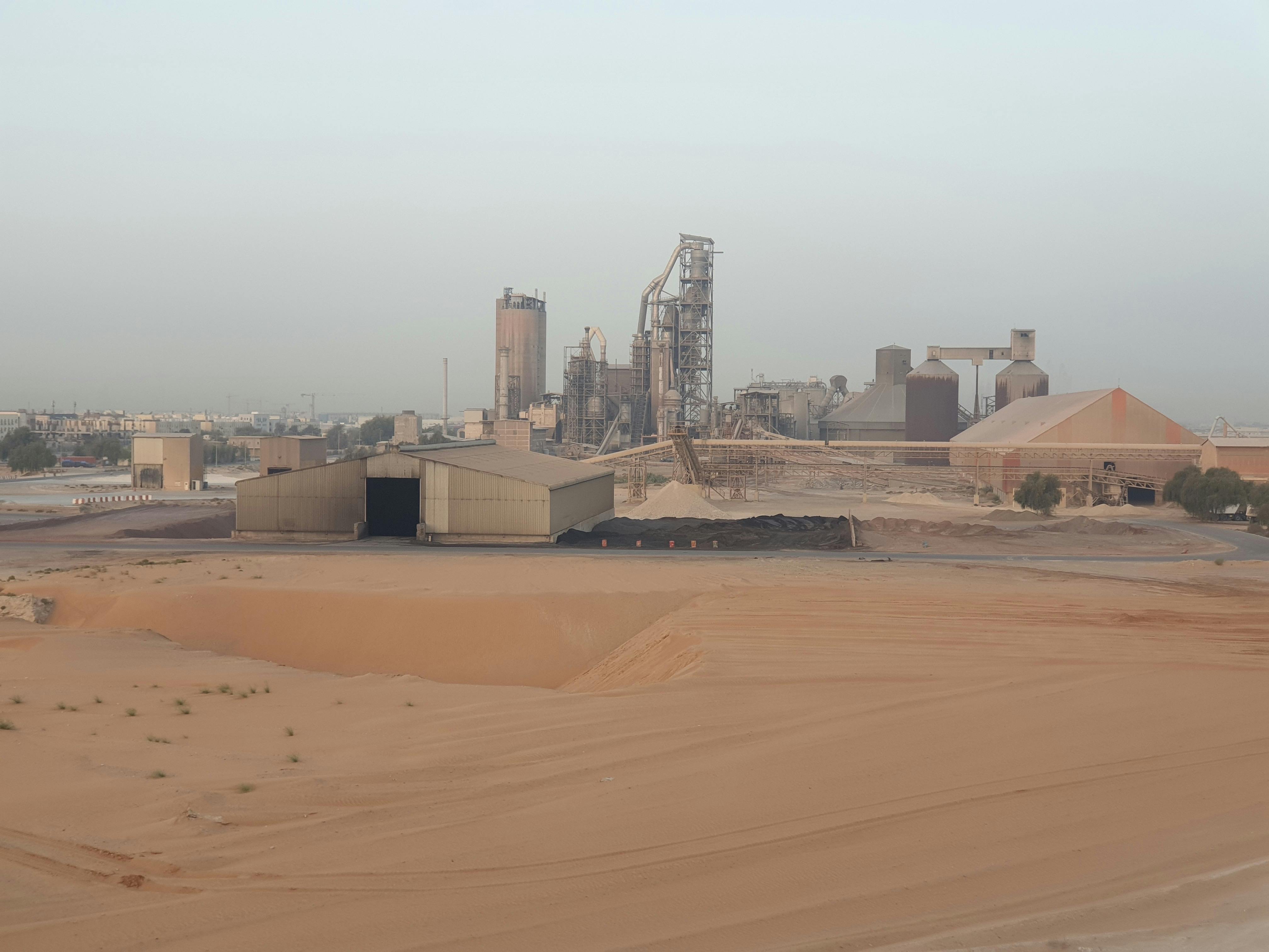 A sprawling industrial complex amid a desert setting on a clear day.