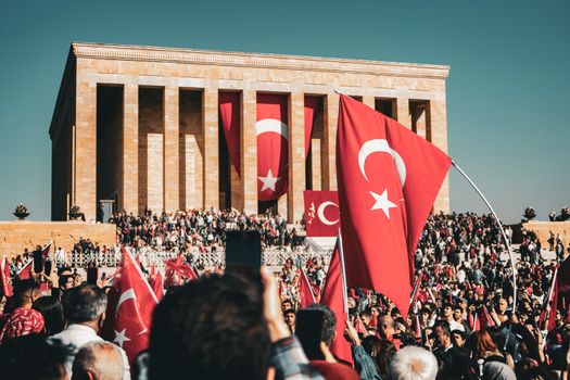 Crowds gather at Anıtkabir waving Turkish flags during a national celebration.