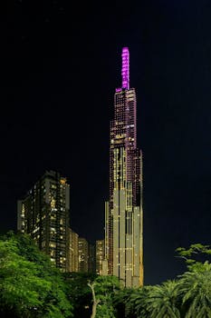 Stunning night view of Landmark 81, a towering skyscraper in Ho Chi Minh City, Vietnam, lit up vibrantly.