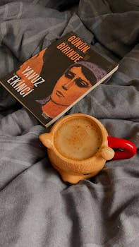 A warm cup of coffee with a book, creating a cozy and relaxing atmosphere.
