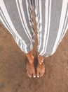 Person Wearing White and Grey Striped-up Pants