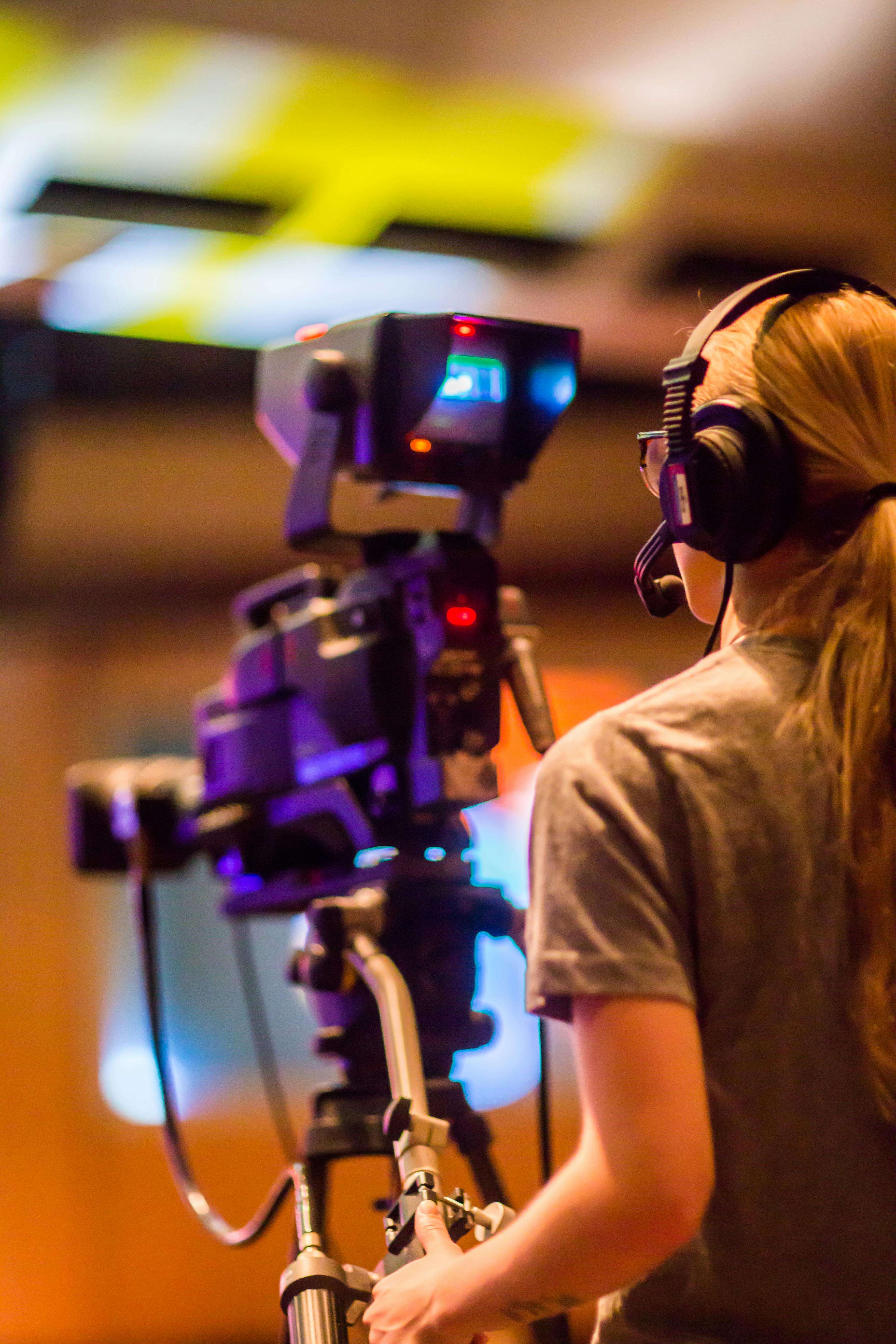 woman standing in front of video camera