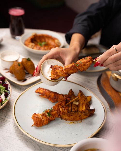 Free Tempting fried chicken with dipping sauce on a beautifully set table. Stock Photo