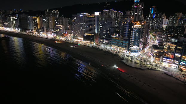 Stunning night view of Busan's illuminated cityscape along the coastline.