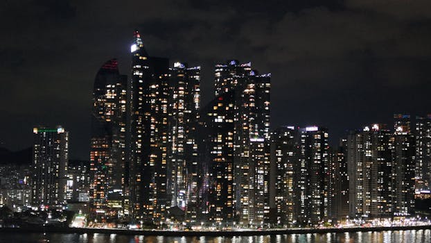 Stunning cityscape of Busan, South Korea, with illuminated skyscrapers at night.