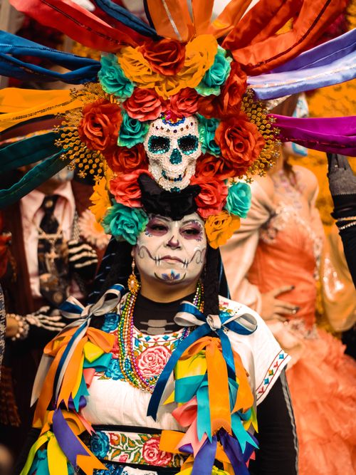 Free Colorful Day of the Dead festivities featuring traditional skull makeup and costumes in Mexico City. Stock Photo