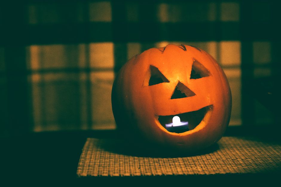 A carved pumpkin glowing with a candle inside, perfect for Halloween ambiance.