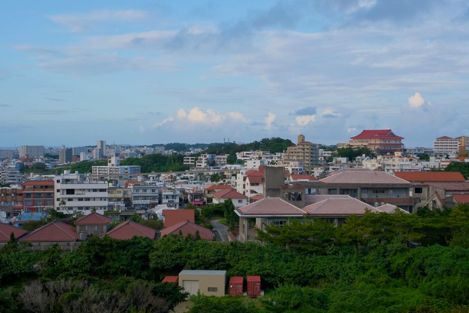 Panoramic view of Okinawa cityscape with traditional and modern buildings.