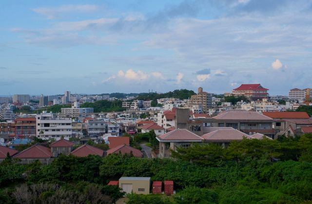 Panoramic view of Okinawa cityscape with traditional and modern buildings. — arriving in Naha