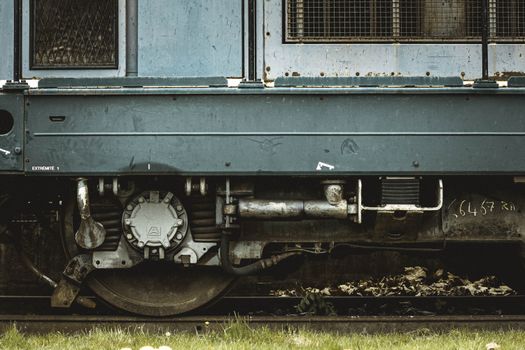 Detailed view of an old train wheel showcasing rustic engineering and metal details.