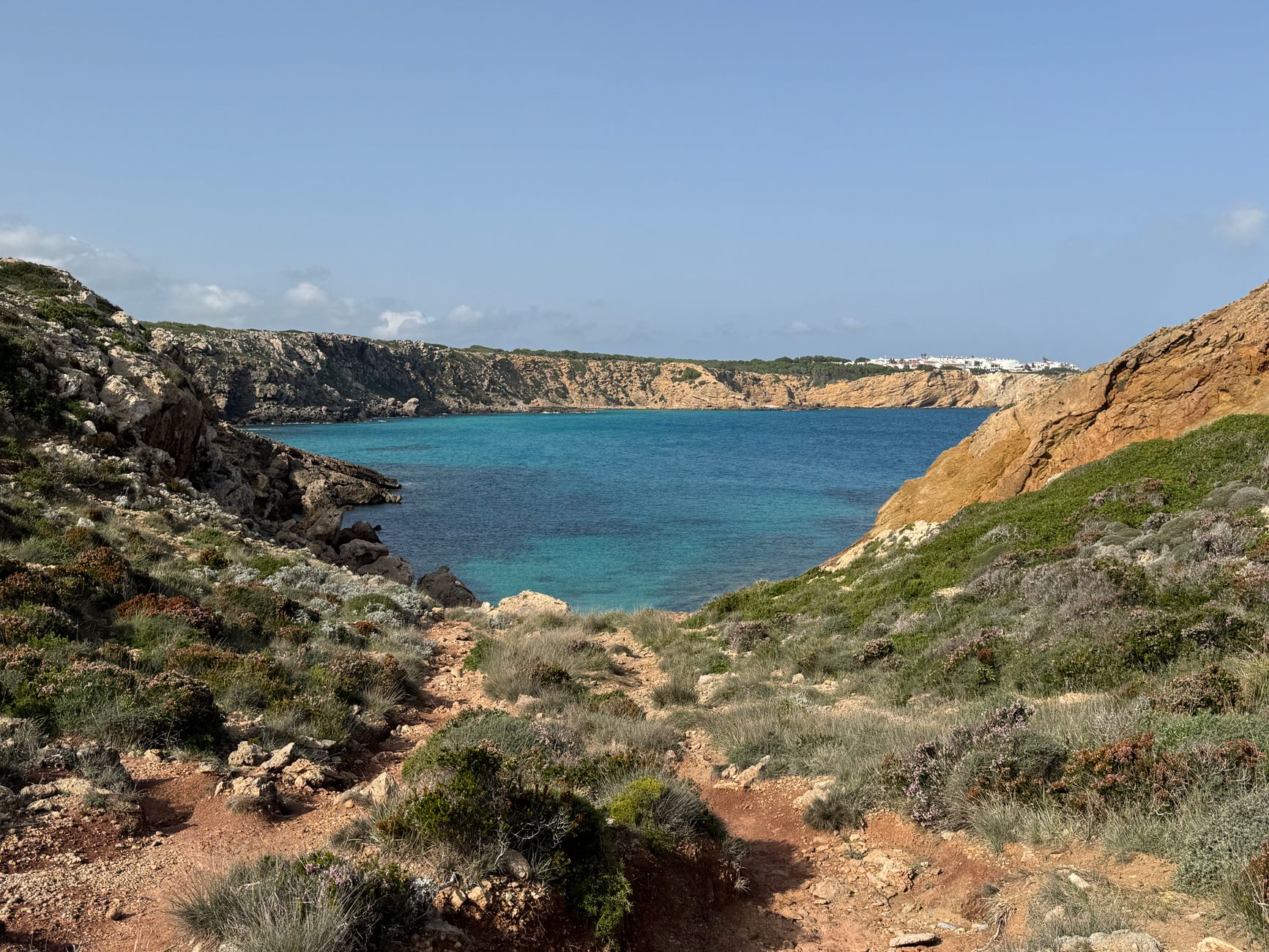 Breathtaking coastal landscape in Menorca with turquoise waters and rugged cliffs.