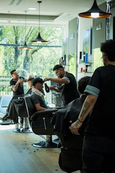 Men receiving haircuts at a stylish barbershop in Cuenca, Ecuador.