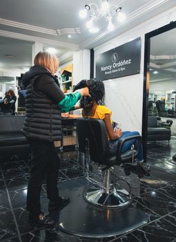 Woman getting hair styled at Nancy Ordóñez Beauty Salon in Cuenca, Ecuador.