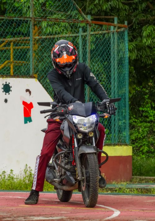 Free Motorcyclist on a black bike with helmet on a sports court in Jaltocán, Mexico. Stock Photo