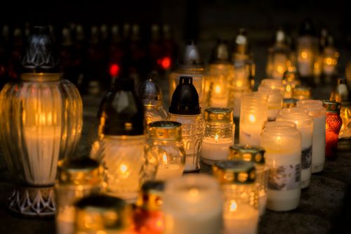 Free Lit candles on a grave, a serene tribute for All Saints' Day, Poland. Stock Photo