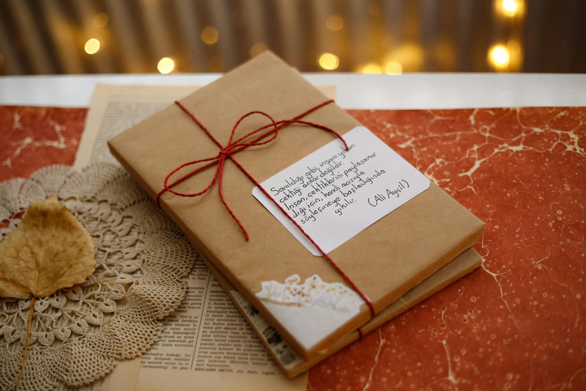 Gift wrapped book on a table with warm lighting, perfect for cozy autumn evenings.