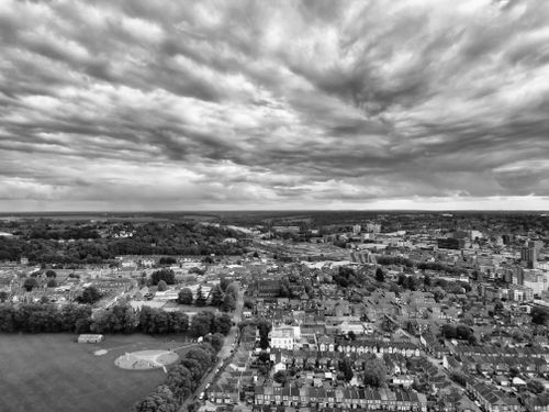 Free Aerial black and white view of Luton, England with dramatic cloud formations. Stock Photo