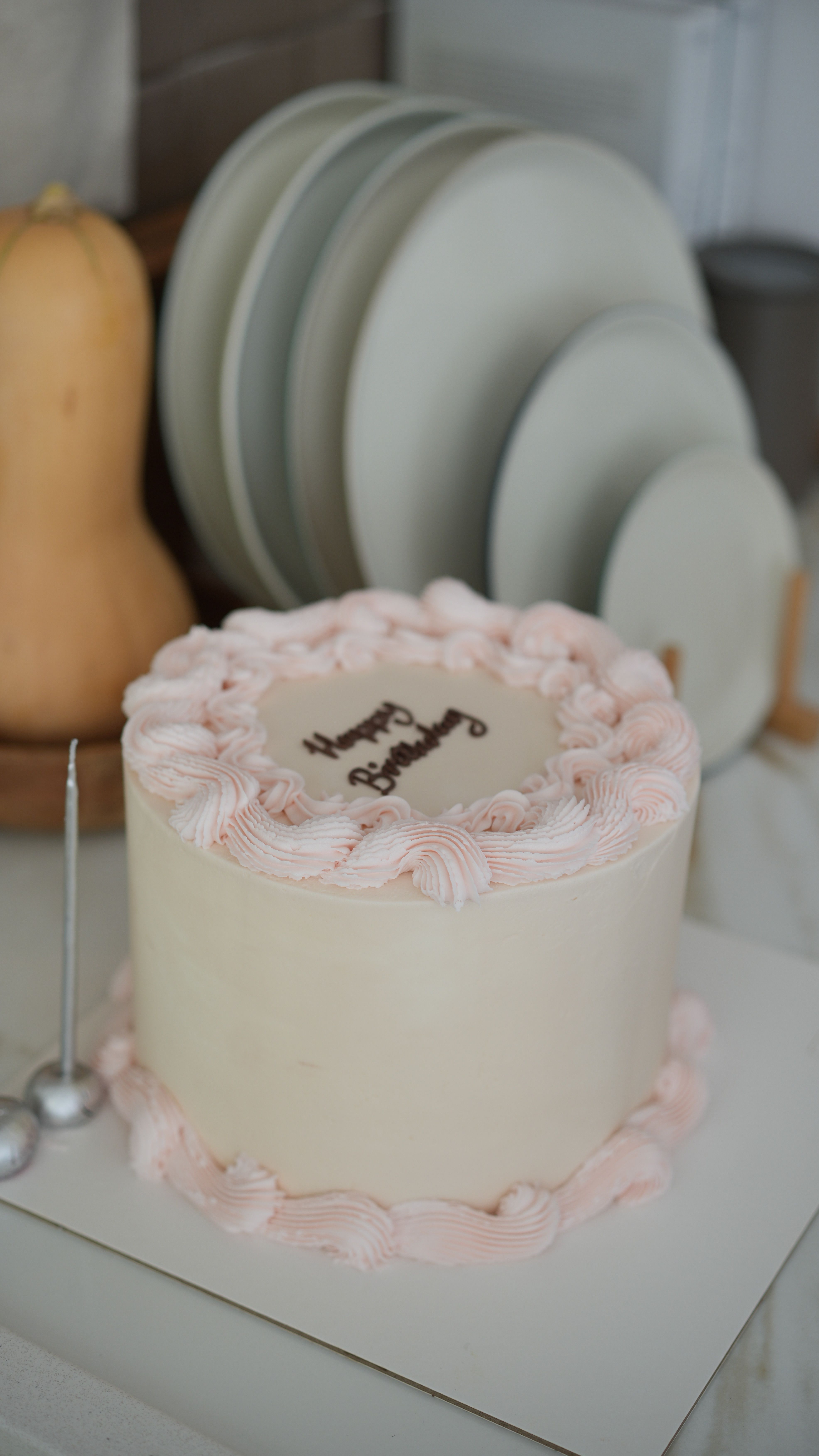 Elegant pastel birthday cake with piped frosting