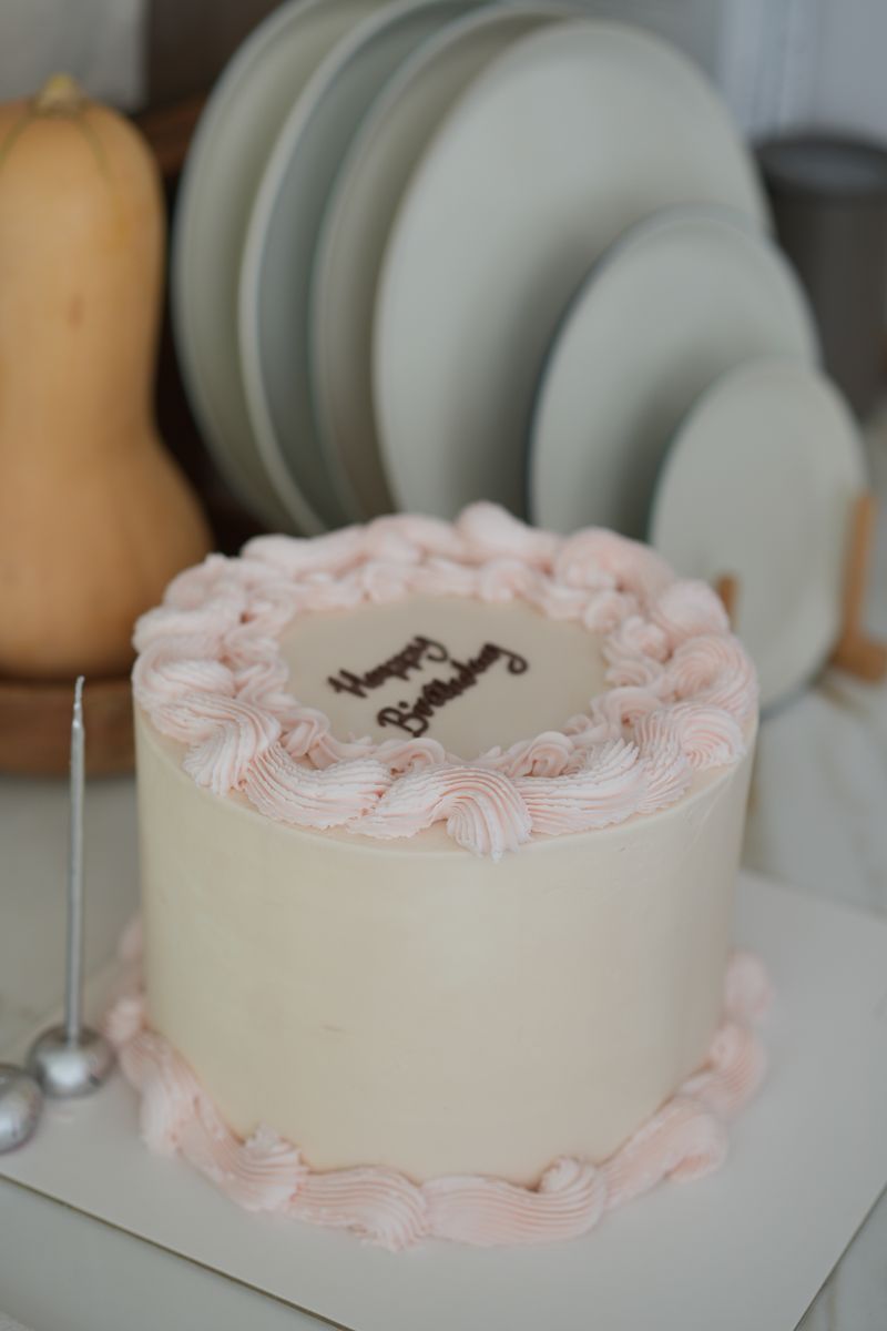 Elegant pastel birthday cake with piped frosting