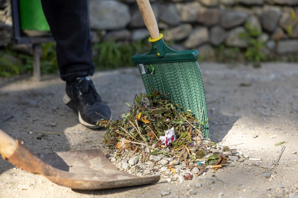 Close-up of outdoor raking and garden cleanup work