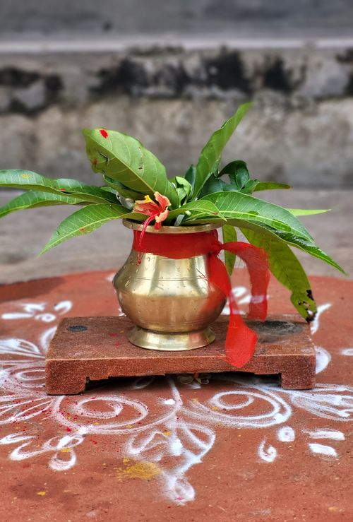 Free A decorative brass pot with leaves on a traditional motif background. Stock Photo