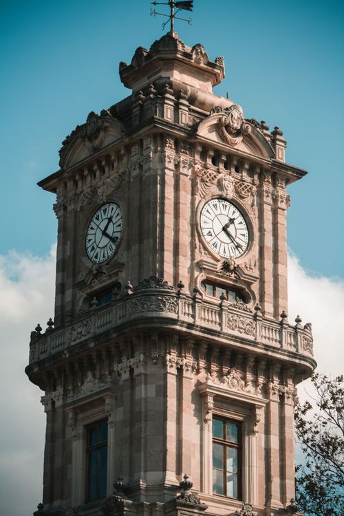 Free A detailed view of the ornate historic clock tower under a clear blue sky in Beşiktaş, Istanbul. Stock Photo