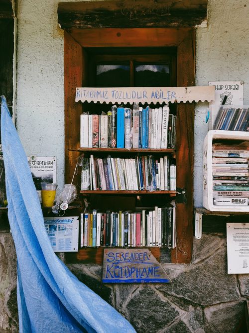 Free Outdoor bookshelf with assorted books in wooden frame, Rize, Türkiye. Stock Photo