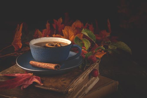Free Blue ceramic cup of tea with cinnamon and autumn leaves providing a warm, cozy atmosphere. Stock Photo