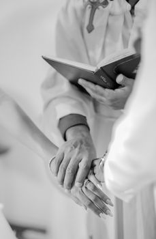Close-up of hands during a wedding ceremony capturing intimate details.