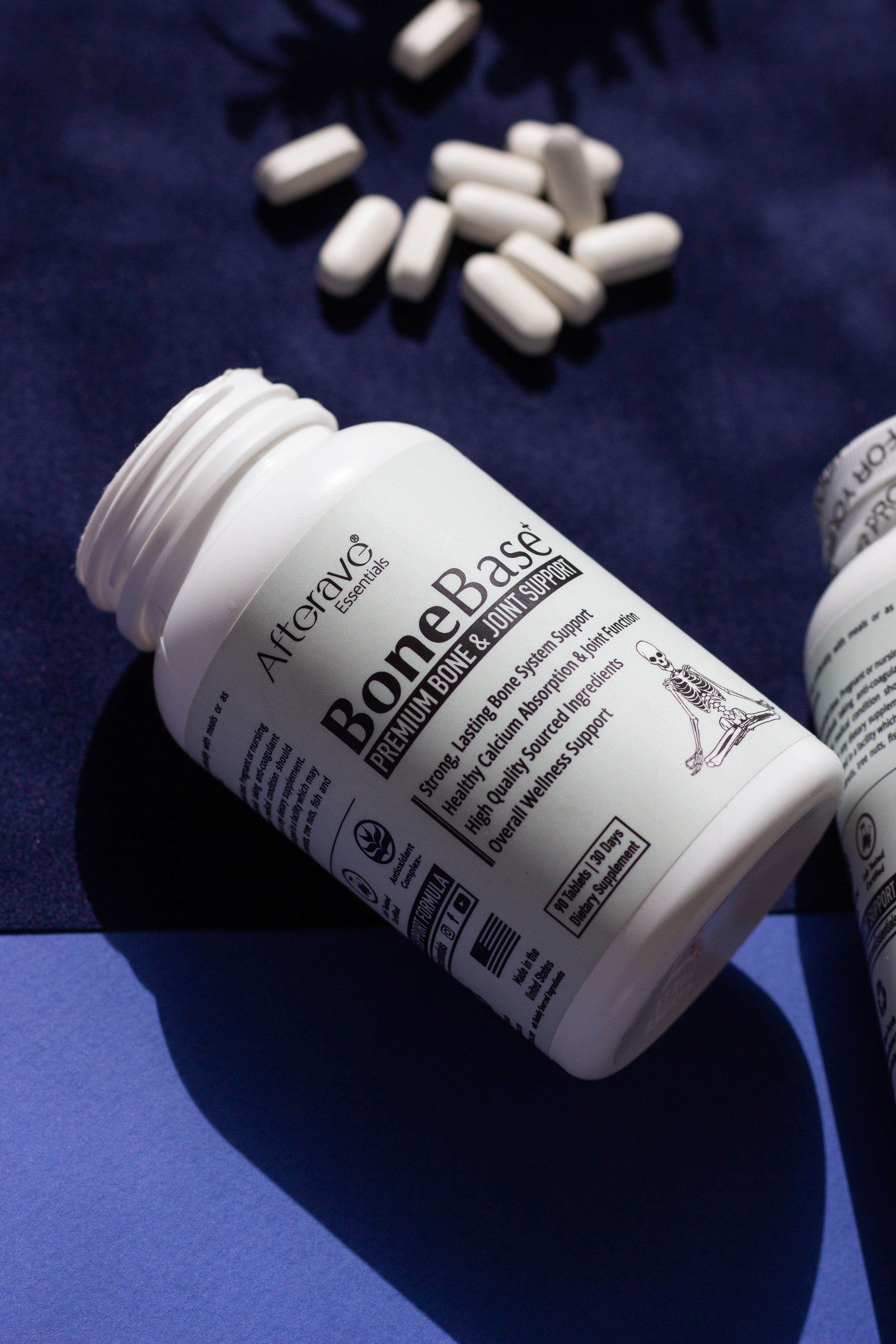 Vitamin supplement bottle with pills promoting bone and joint health on display.