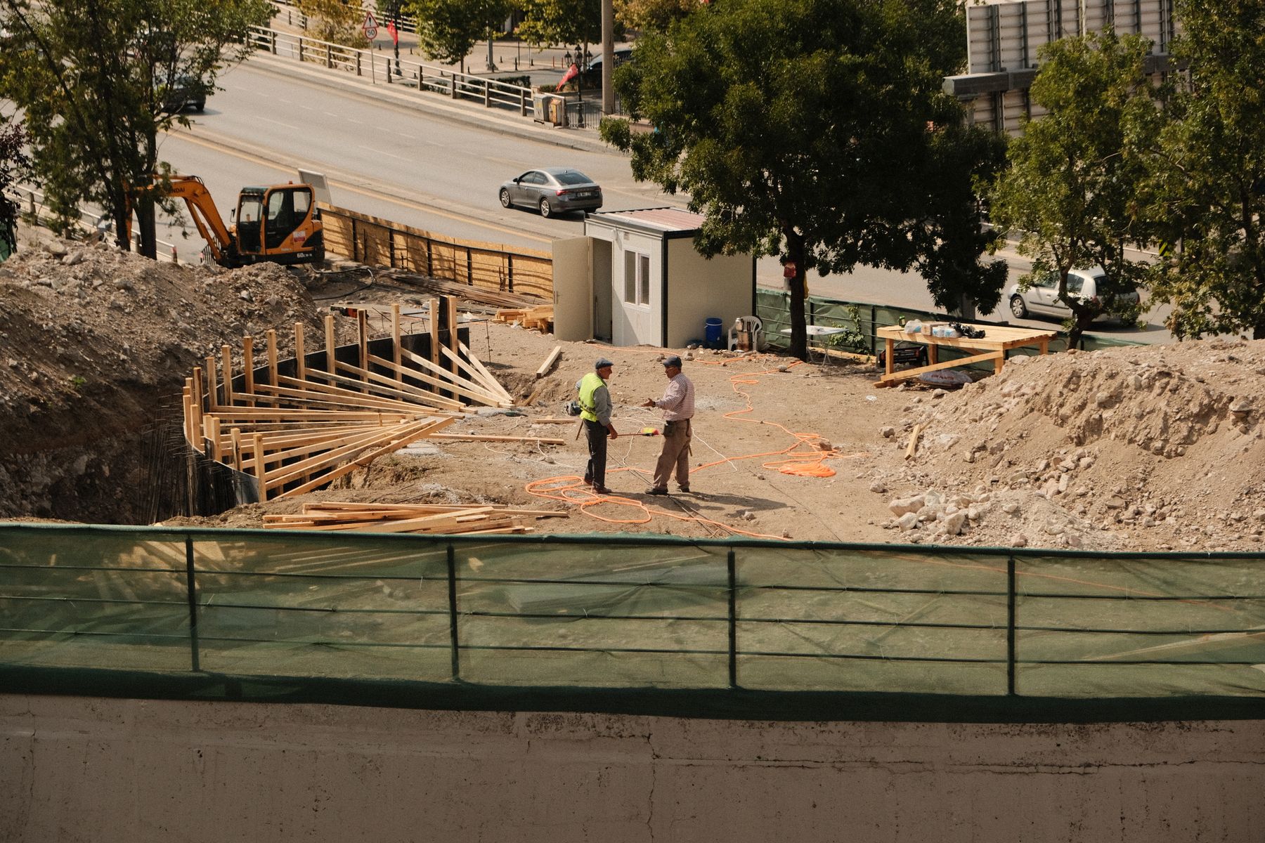 Construction professionals reviewing plans at a property development site
