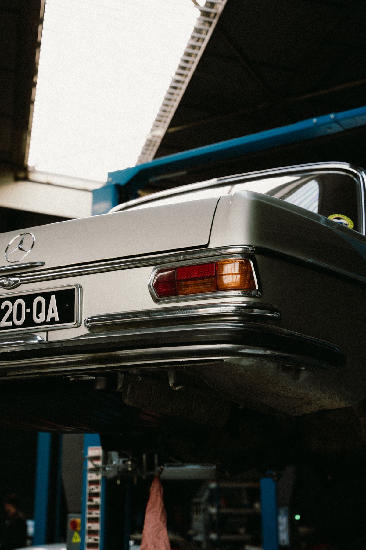 Ilustrasi pemeriksaan bagian bawah Mercedes-Benz menggunakan lift workshop